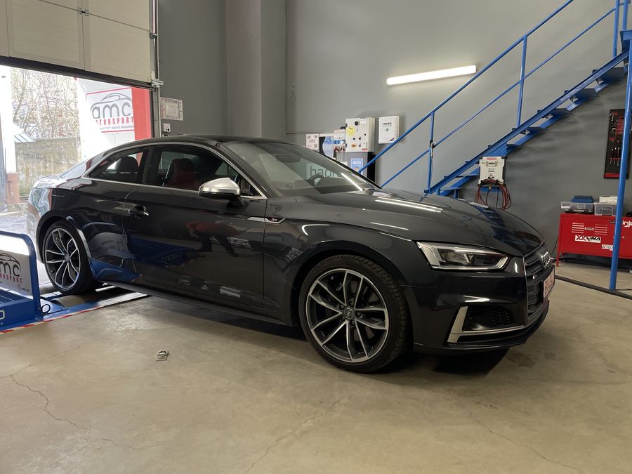 Black Audi coupe in the AMC Motorsport workshop