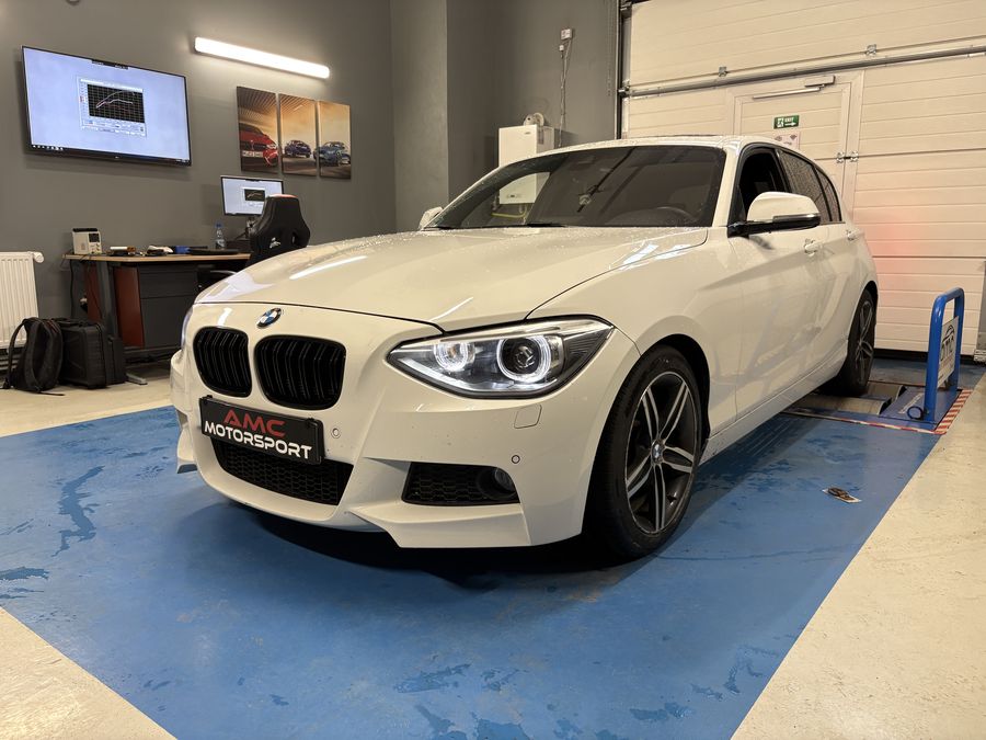 White BMW 1 Series in the AMC Motorsport workshop